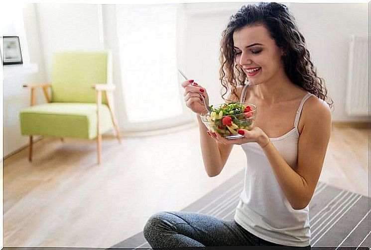 girl eating salad on the floor