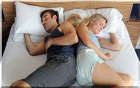 the couple sleeps with their backs facing each other