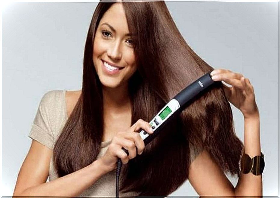 woman straightens hair